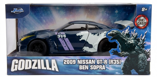 Model car packaging featuring Godzilla and a Nissan GT-R with a blue and white design.