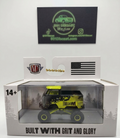 Model truck in packaging with 'Built with Grit and Glory' text, brand logo, and American flag.