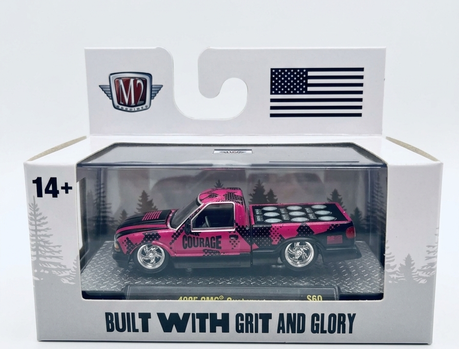 Model truck in packaging with 'M2' branding and American flag on a white background